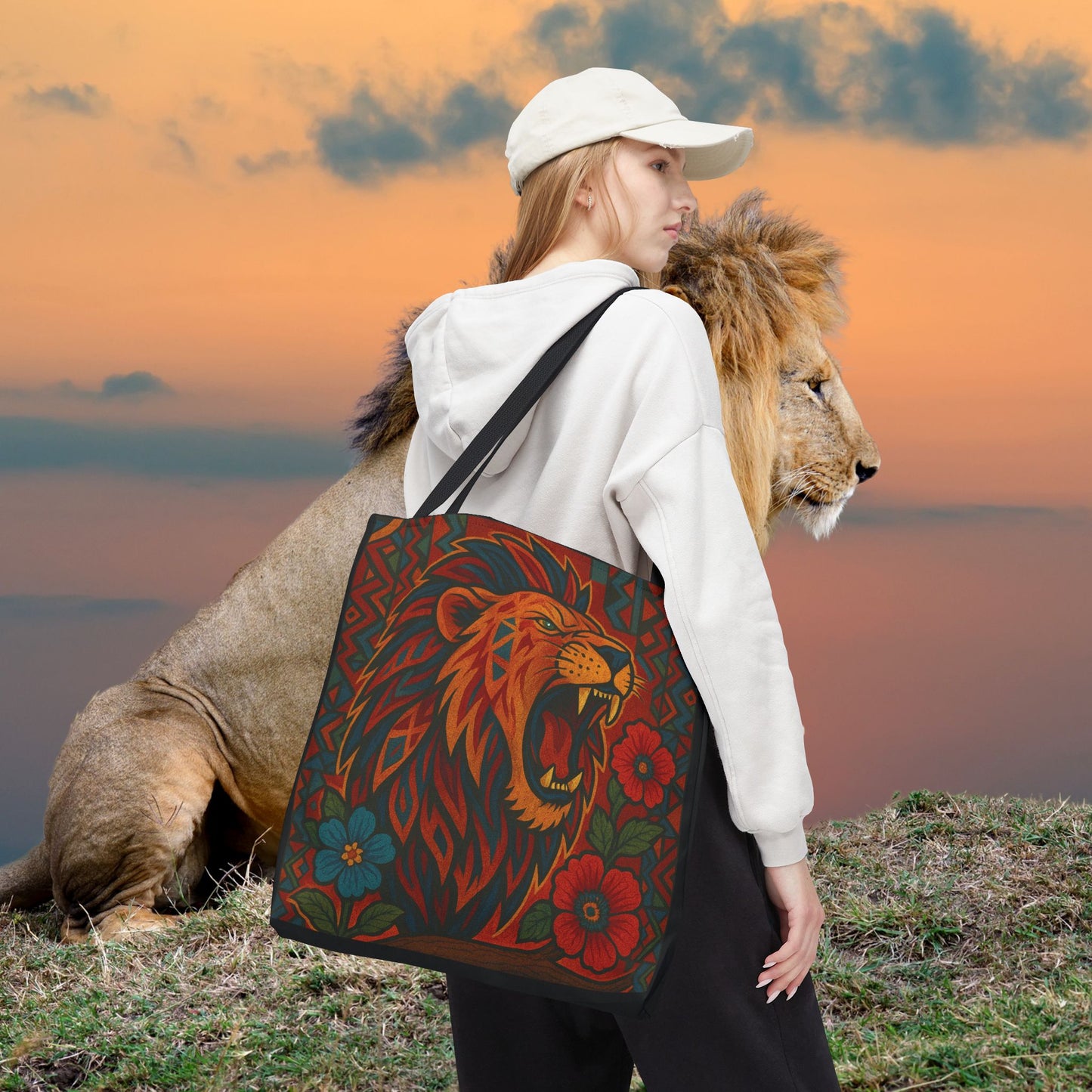 Mashafrica tote bag with bold roaring lion and floral print carried by woman at sunset with lion nearby