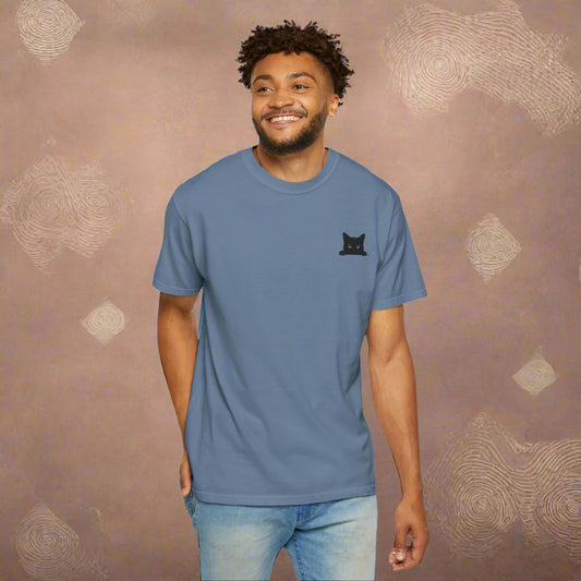Mashafrica blue casual shirt with small black cat logo on chest modeled by smiling man in jeans