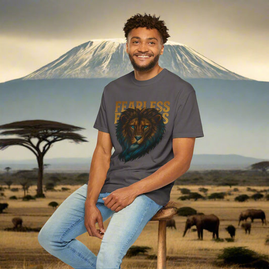 Mashafrica mens T shirt with fearless lion graphic worn by smiling man in African savanna setting