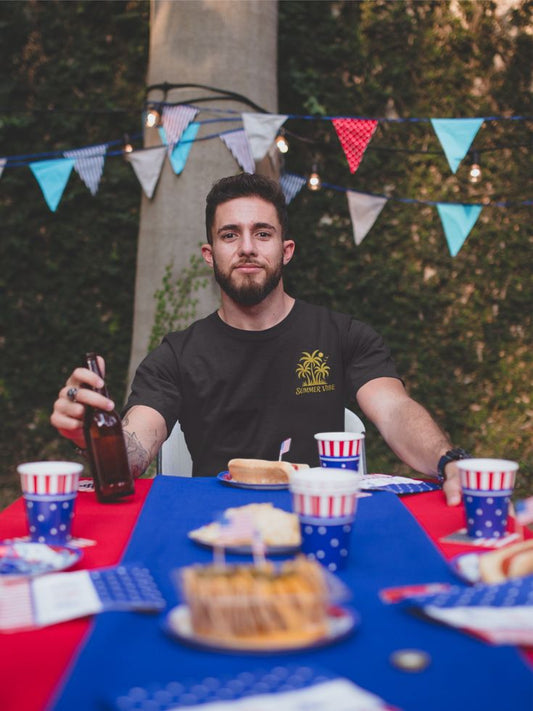 Mashafrica black t shirt with yellow palm logo worn by man at outdoor party summer vibe casual tee