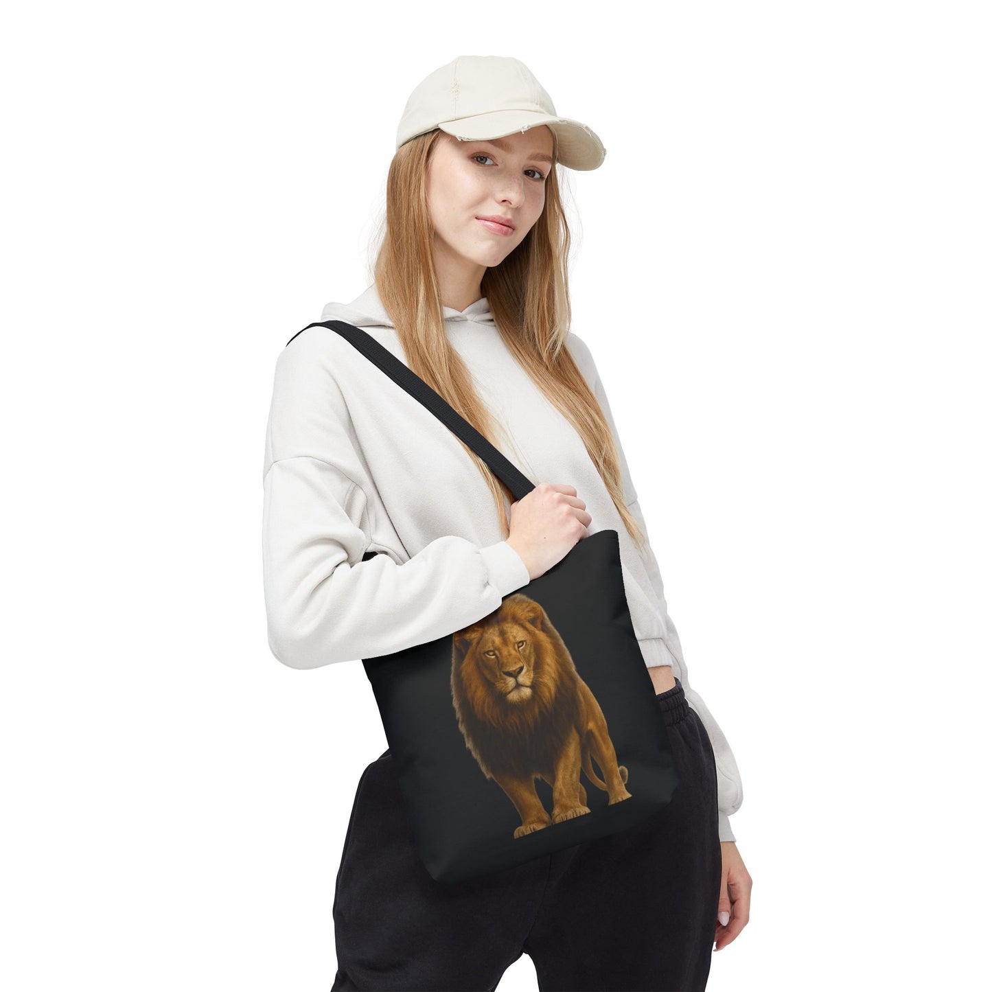 Mashafrica black tote bag with realistic lion print worn crossbody by woman in white hoodie