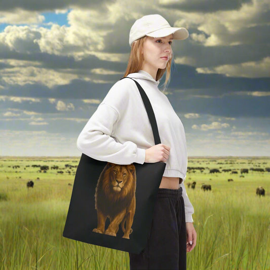 Mashafrica black tote bag with realistic lion print carried by woman in white hoodie in savanna