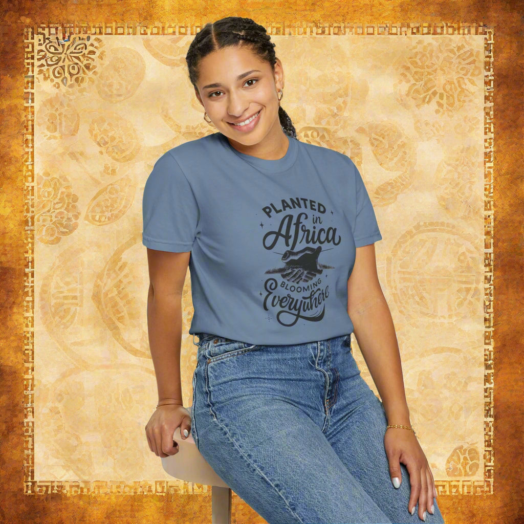 Mashafrica blue crew neck t shirt with planted in africa graphic worn by smiling woman seated with jeans