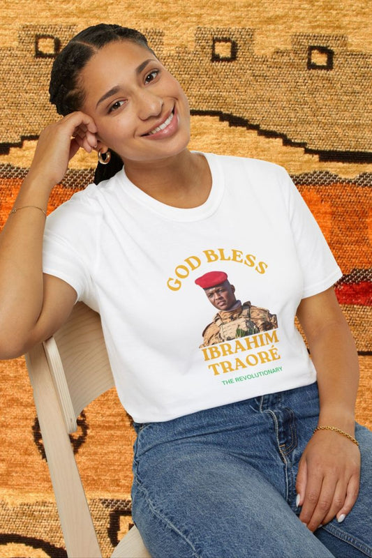 Mashafrica white t shirt with God Bless Ibrahim Traore portrait graphic worn by smiling woman seated