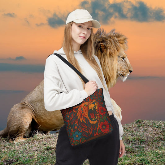 Mashafrica tote bag with bold red and teal lion print worn crossbody by woman at sunset with lion