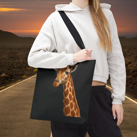 Mashafrica black canvas tote bag with realistic giraffe print shown on model wearing hoodie at sunset