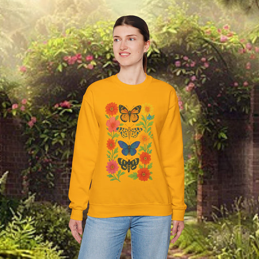 Mashafrica yellow sweatshirt with colorful butterfly and floral print worn by model in garden backdrop