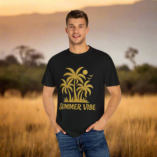 Mashafrica black t shirt with gold palm tree summer vibe print worn by smiling man in sunset field