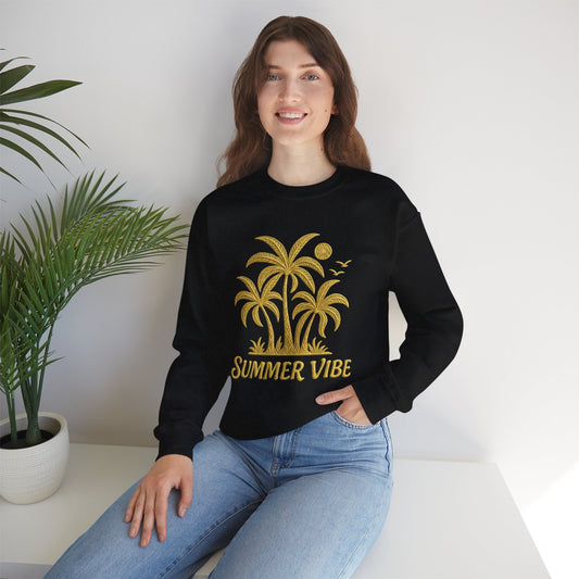 Mashafrica black sweatshirt with gold palm tree summer vibe print worn by smiling woman seated in jeans indoor plant