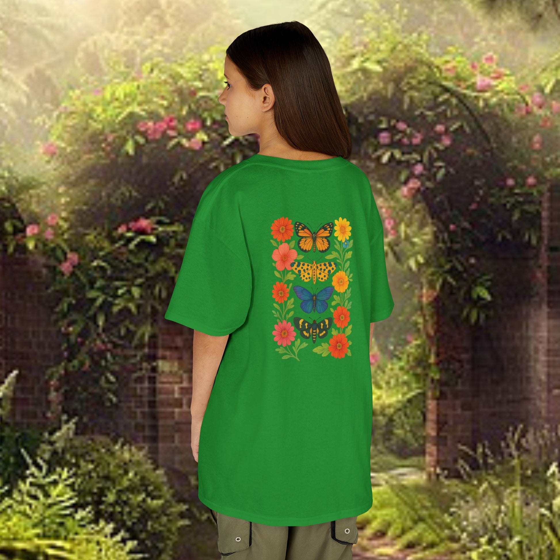 Mashafrica green kids t shirt with colorful butterfly and flower back print worn by child in garden