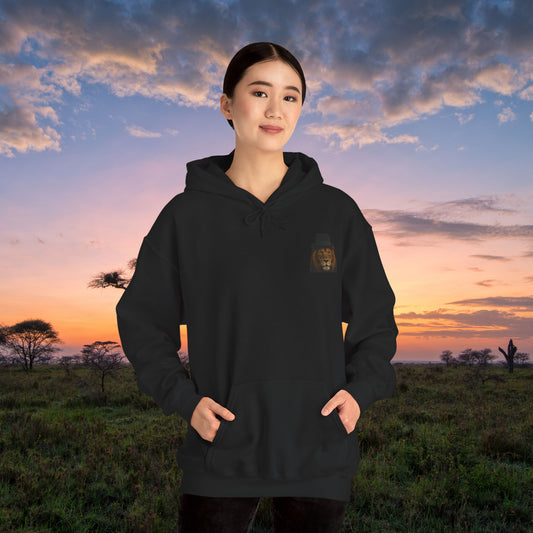 Mashafrica black hoodie with small lion chest patch on model wearing kangaroo pocket against African sunset