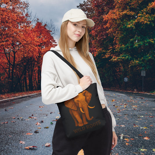 Mashafrica black tote bag with orange elephant Wild Roots print carried by young woman in white cap on autumn tree lined road